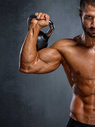 Fit man lifting weights, representing strength, vitality, and men’s longevity through resistance training.